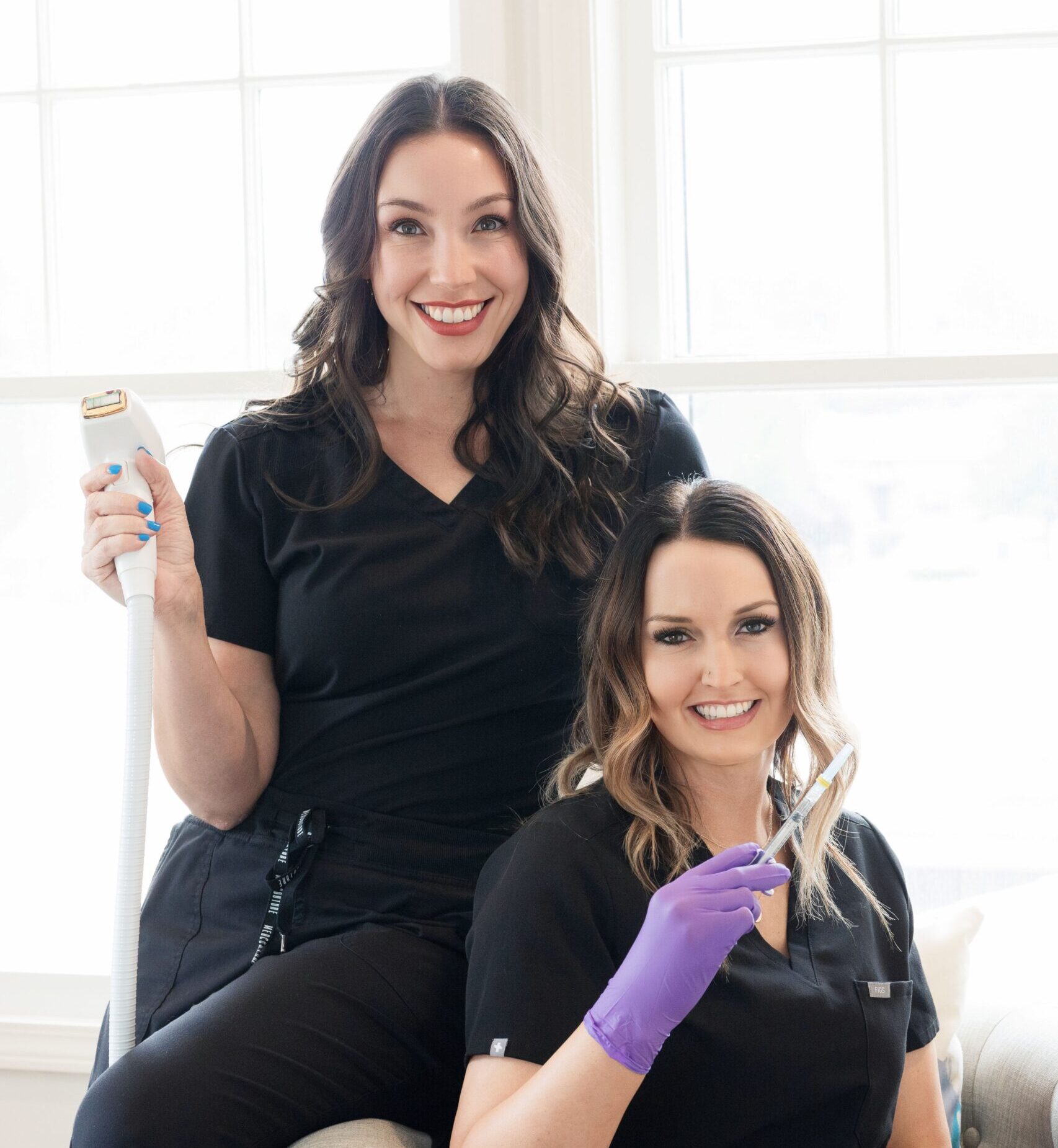 two employees holding wellness tech