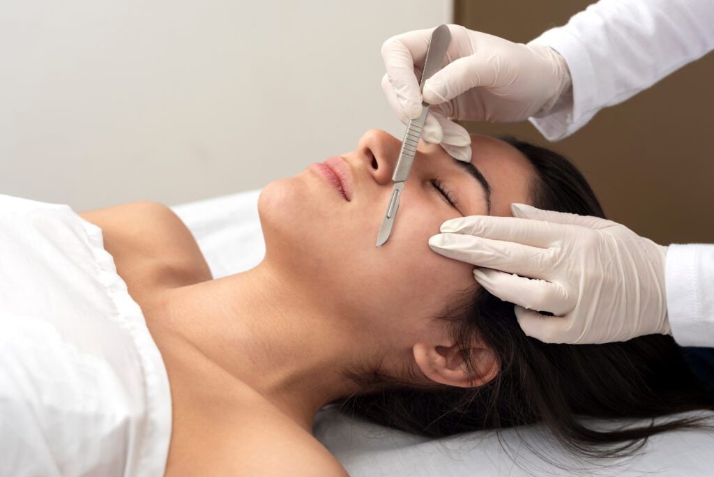 young woman on a table in a beauty center performing a beauty treatment for facial skin with the dermaplaning technique